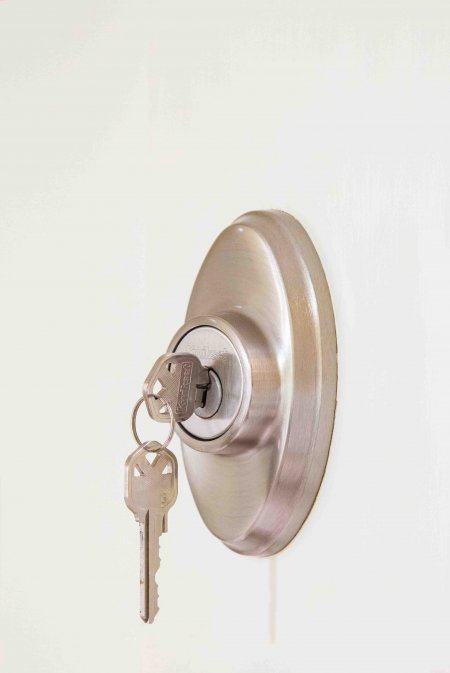 silver keys hanging from home door lock